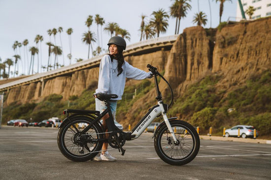 Woman with eBike below the bluffs at the beach