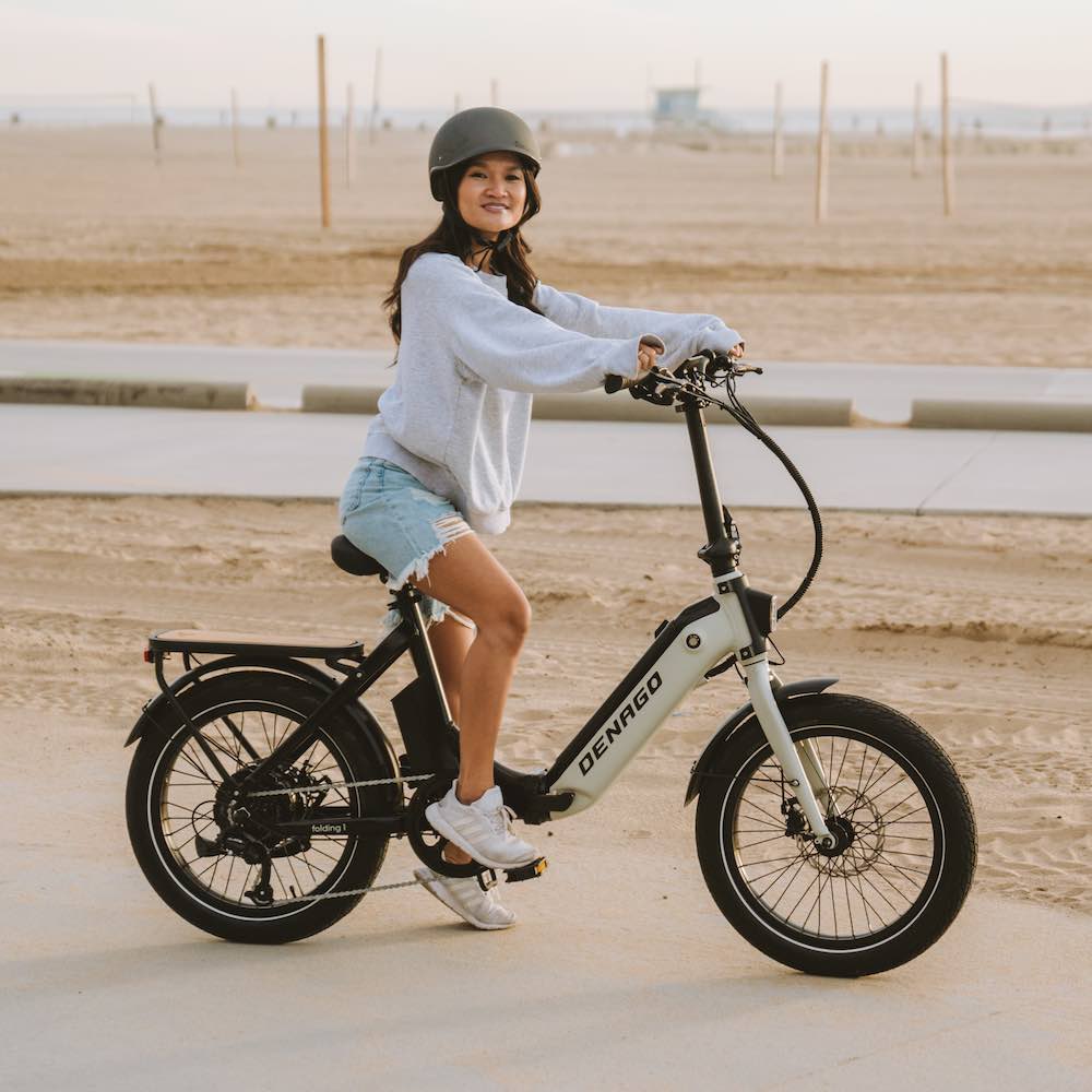 Tam riding Denago Folding 1 eBike at the beach