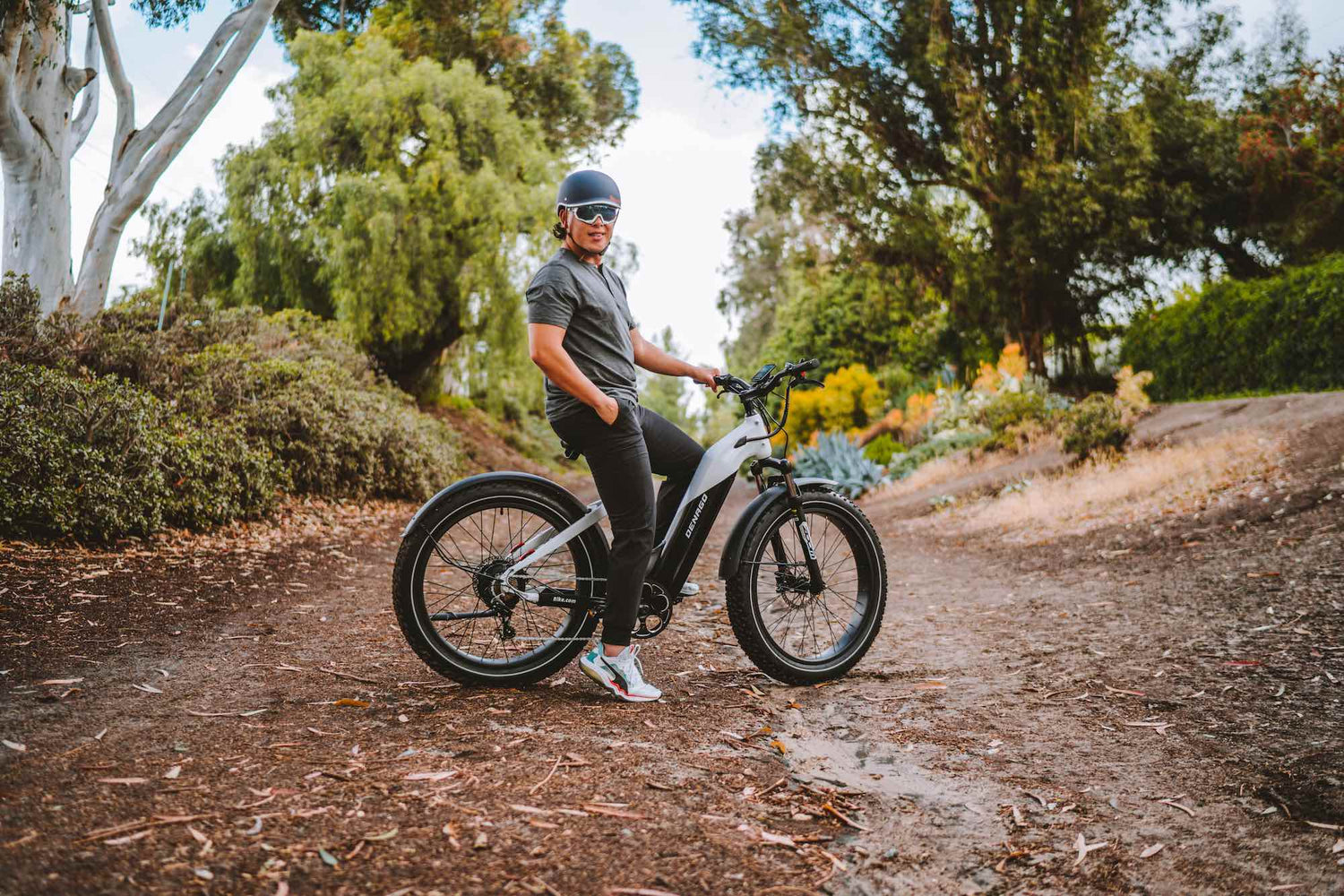 Man straddling a Denago fat tire eBike on the Fullerton Loop trail