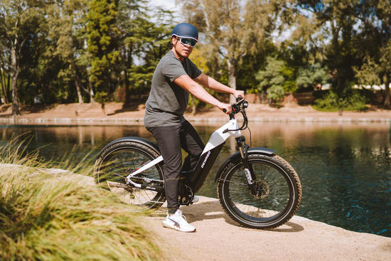 Man standing next to a lake with a Denago eBike