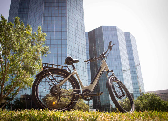Denago eBike parked in front of a glass office tower