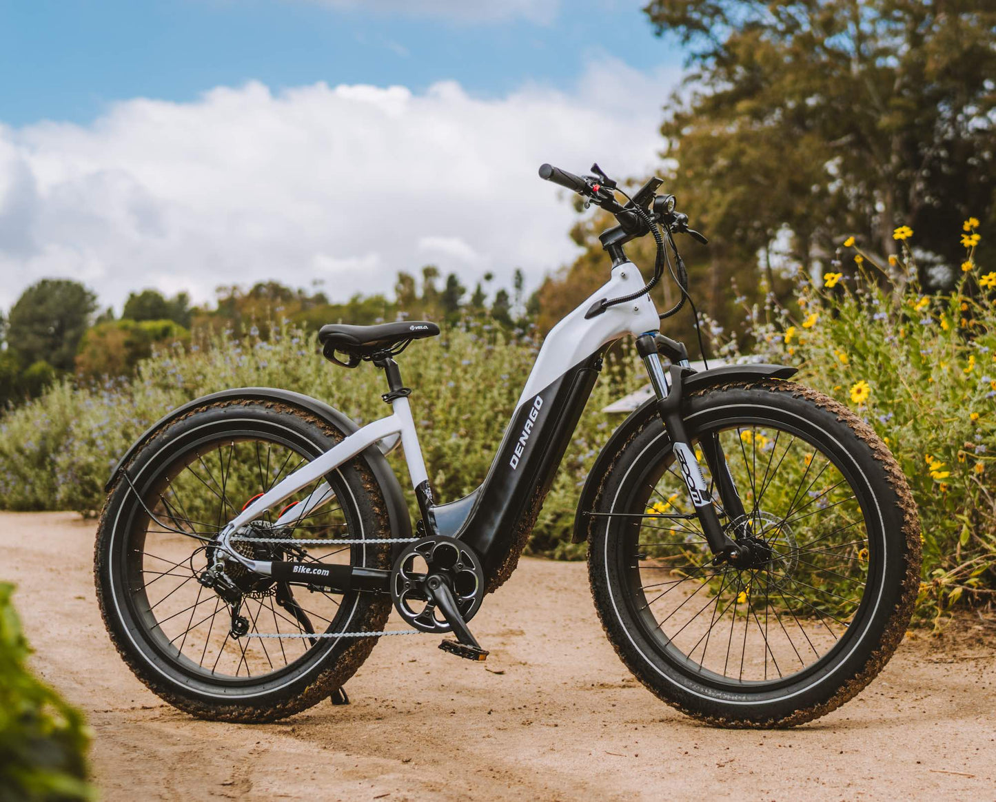 A Denago Fat Model 1 eBike with sunflowers on a cloudy day